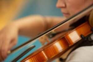 close up of woman playing a violin