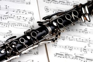 clarinet lying on top of sheet music